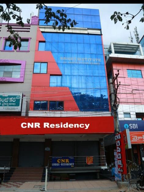 CNR Residency building on Kadiri Road, with the red signboard above Popular Shoe Mart